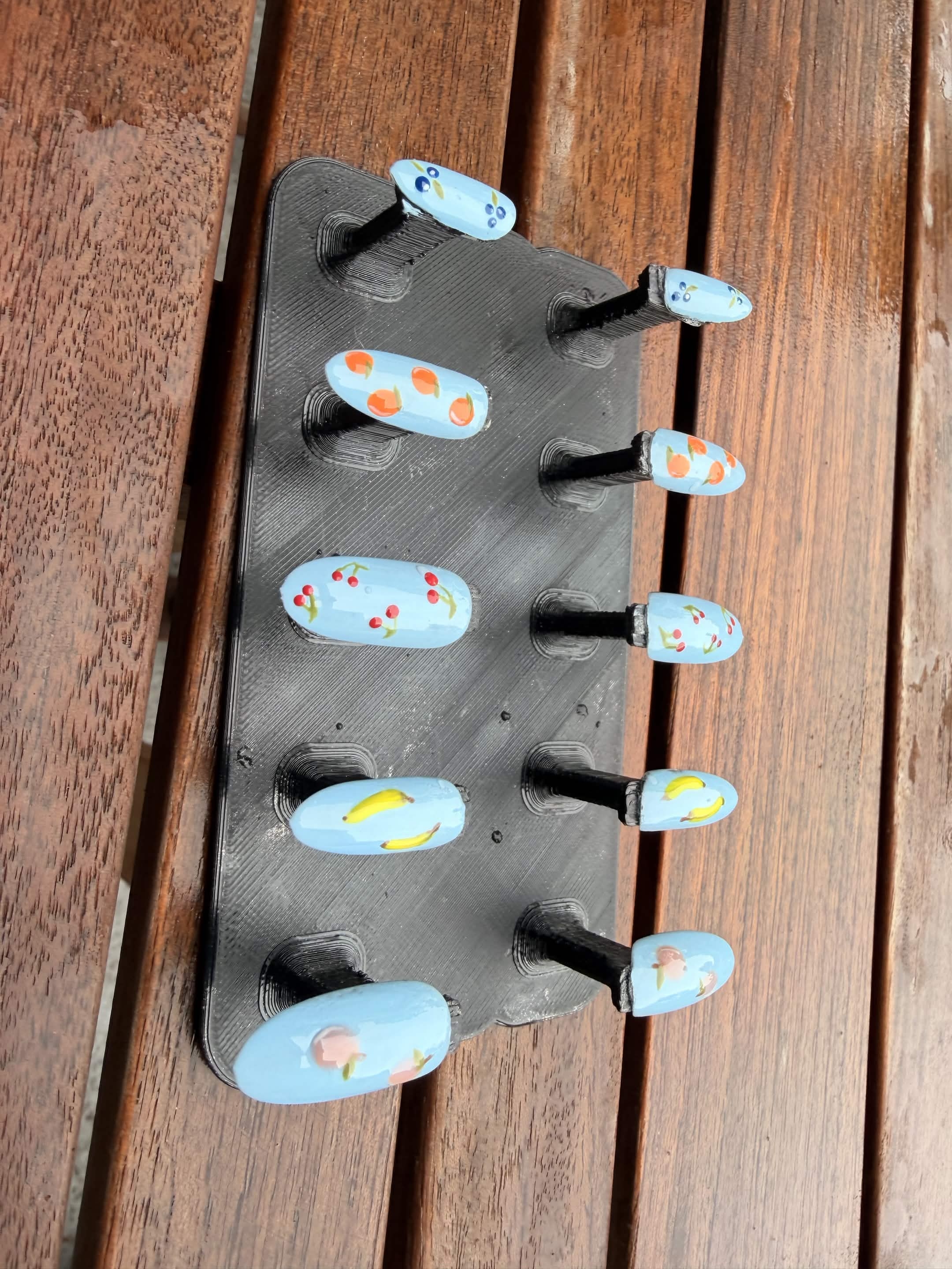 Sky blue nails with hand-painted fruit and floral accents