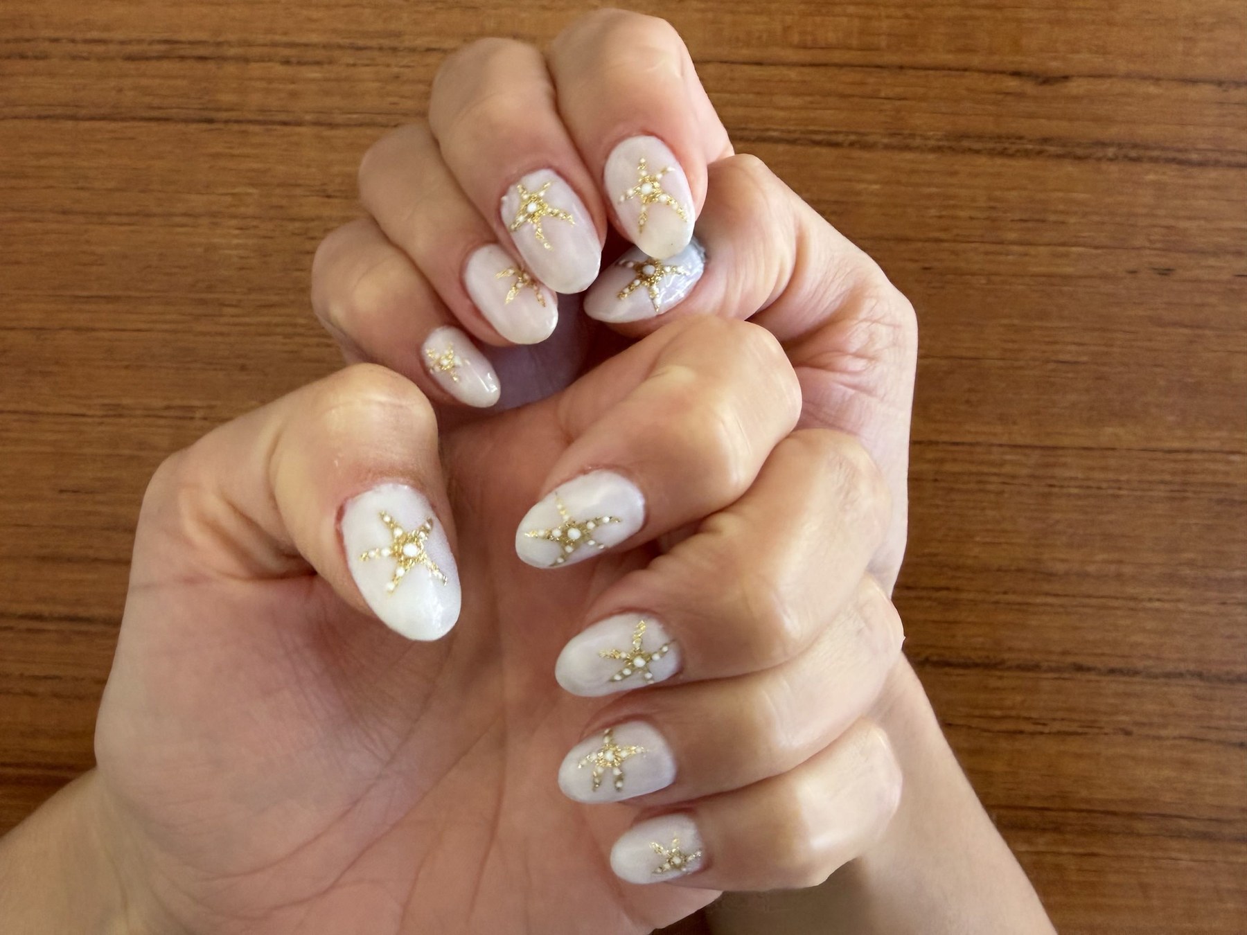 Milky white pearl marble nails with gold starfish charms